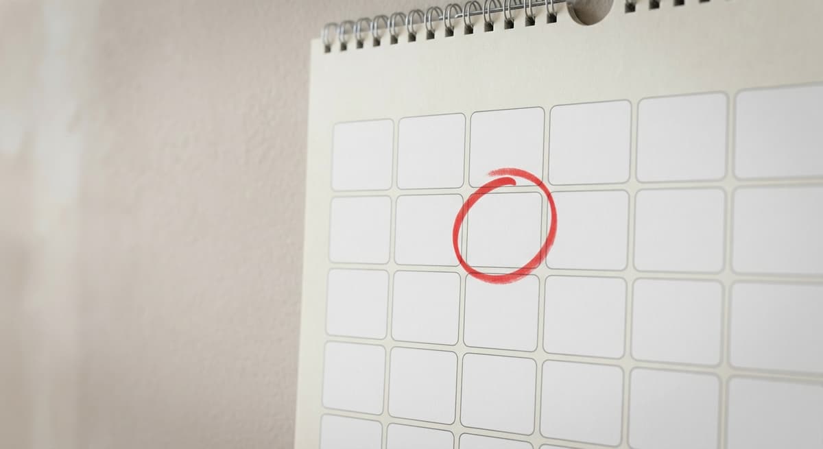 a wall calendar with one date circled in red marker, no people